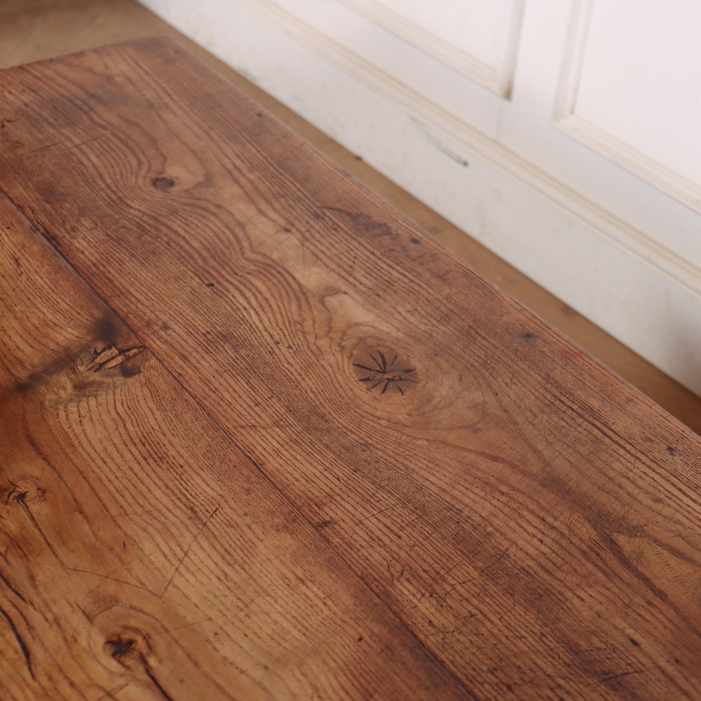 A square, low-profile coffee table crafted from solid brown elm featuring straight legs and an X-shaped cross-stretcher base. View VI