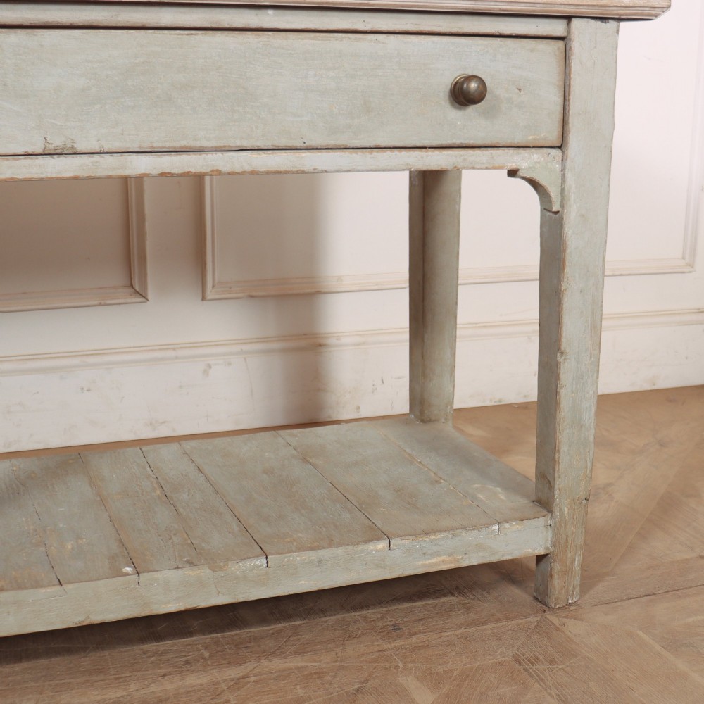 An English painted wooden potboard dresser base with a scrubbed timber top, two drawers, turned legs, and an open slatted lower shelf. View VII