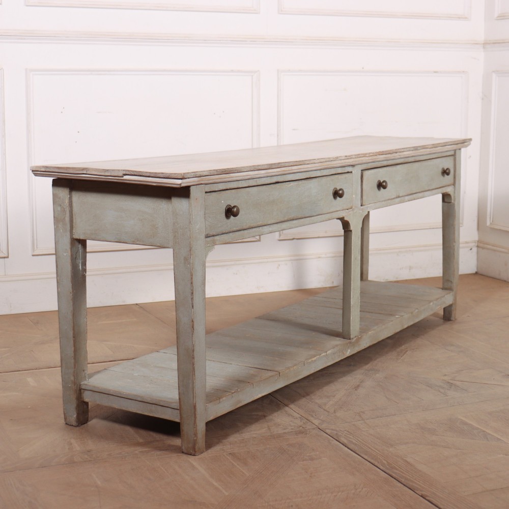 An English painted wooden potboard dresser base with a scrubbed timber top, two drawers, turned legs, and an open slatted lower shelf. View VIII