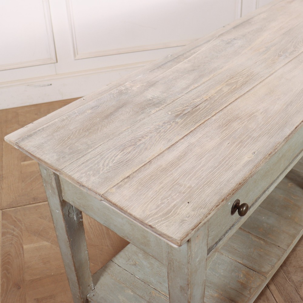 An English painted wooden potboard dresser base with a scrubbed timber top, two drawers, turned legs, and an open slatted lower shelf. View IX