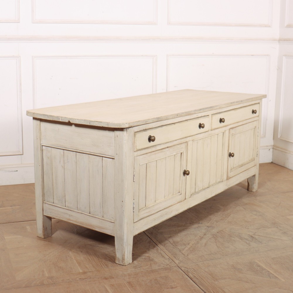 An English painted wood dresser base featuring two long top drawers with brass knob handles above panelled cupboard doors. View IX