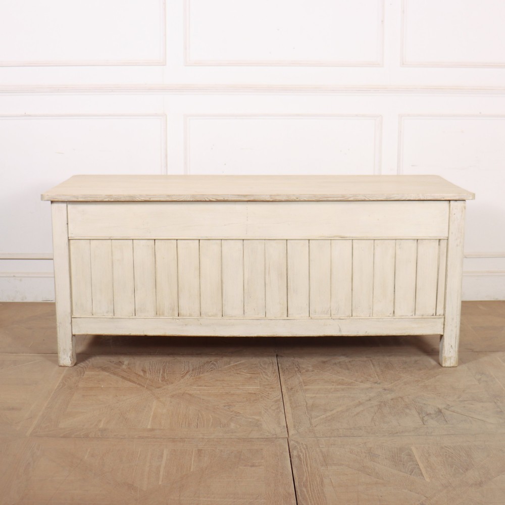 An English painted wood dresser base featuring two long top drawers with brass knob handles above panelled cupboard doors. View XII