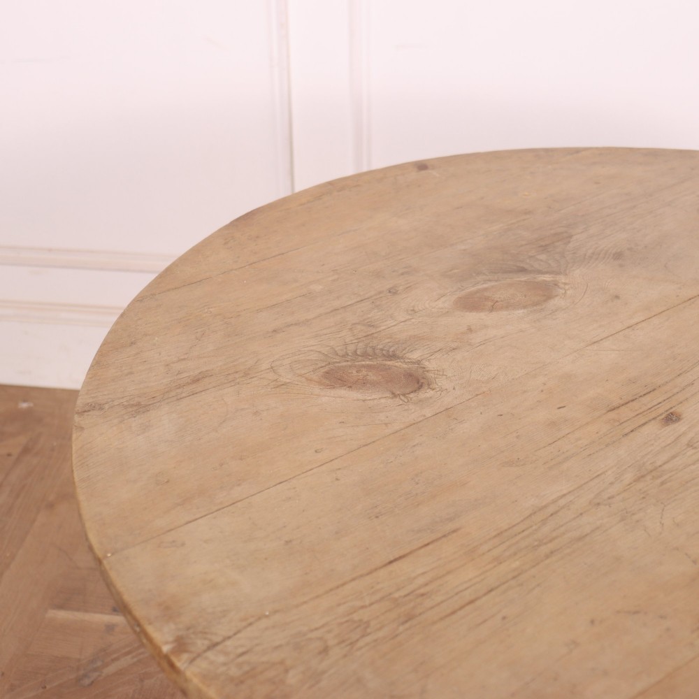 A 19th-century circular Welsh tavern table constructed from light pine with a frieze drawer, turned legs, and an X-frame stretcher. View VI