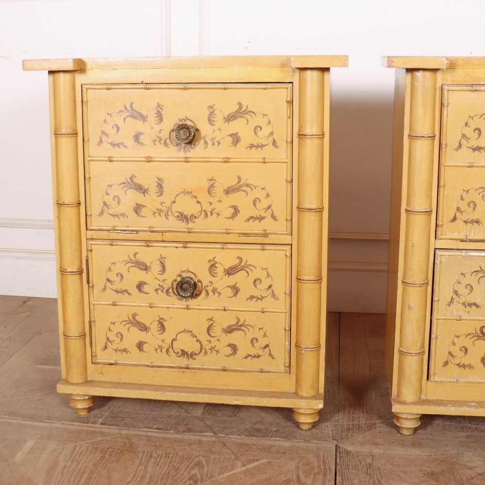 A pair of 19th-century pale yellow painted bedside cabinets featuring turned faux bamboo corner columns and hand-painted foliate motifs. View II