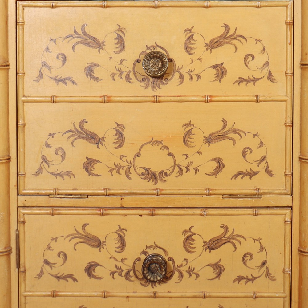 A pair of 19th-century pale yellow painted bedside cabinets featuring turned faux bamboo corner columns and hand-painted foliate motifs. View IV