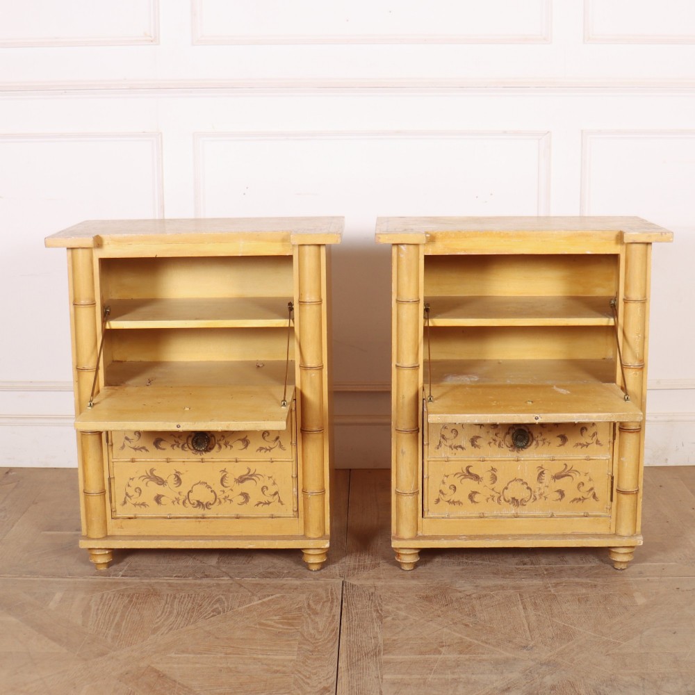 A pair of 19th-century pale yellow painted bedside cabinets featuring turned faux bamboo corner columns and hand-painted foliate motifs. View IX