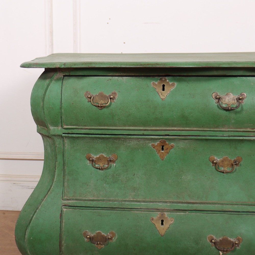 A green painted Dutch bombe commode with three drawers, brass drop handles, keyhole escutcheons, and carved feet. View II