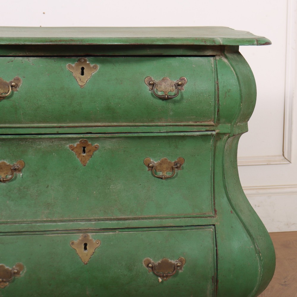 A green painted Dutch bombe commode with three drawers, brass drop handles, keyhole escutcheons, and carved feet. View III