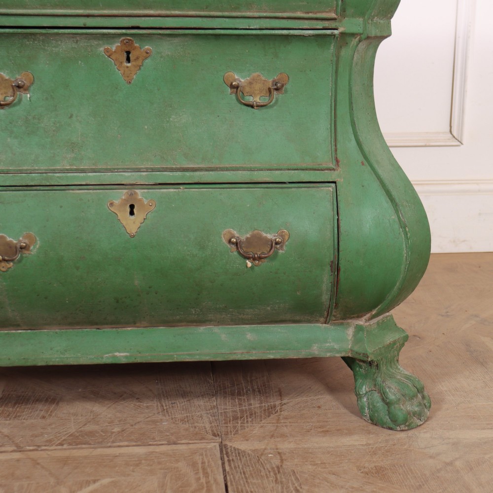 A green painted Dutch bombe commode with three drawers, brass drop handles, keyhole escutcheons, and carved feet. View IV