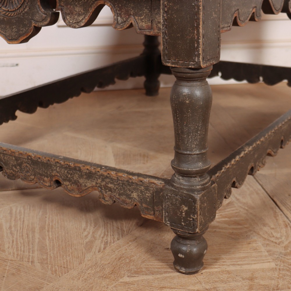 A low rectangular coffee table with a scrubbed pine top and dark painted frame featuring scalloped aprons, a carved shell motif, and turned legs. View VI