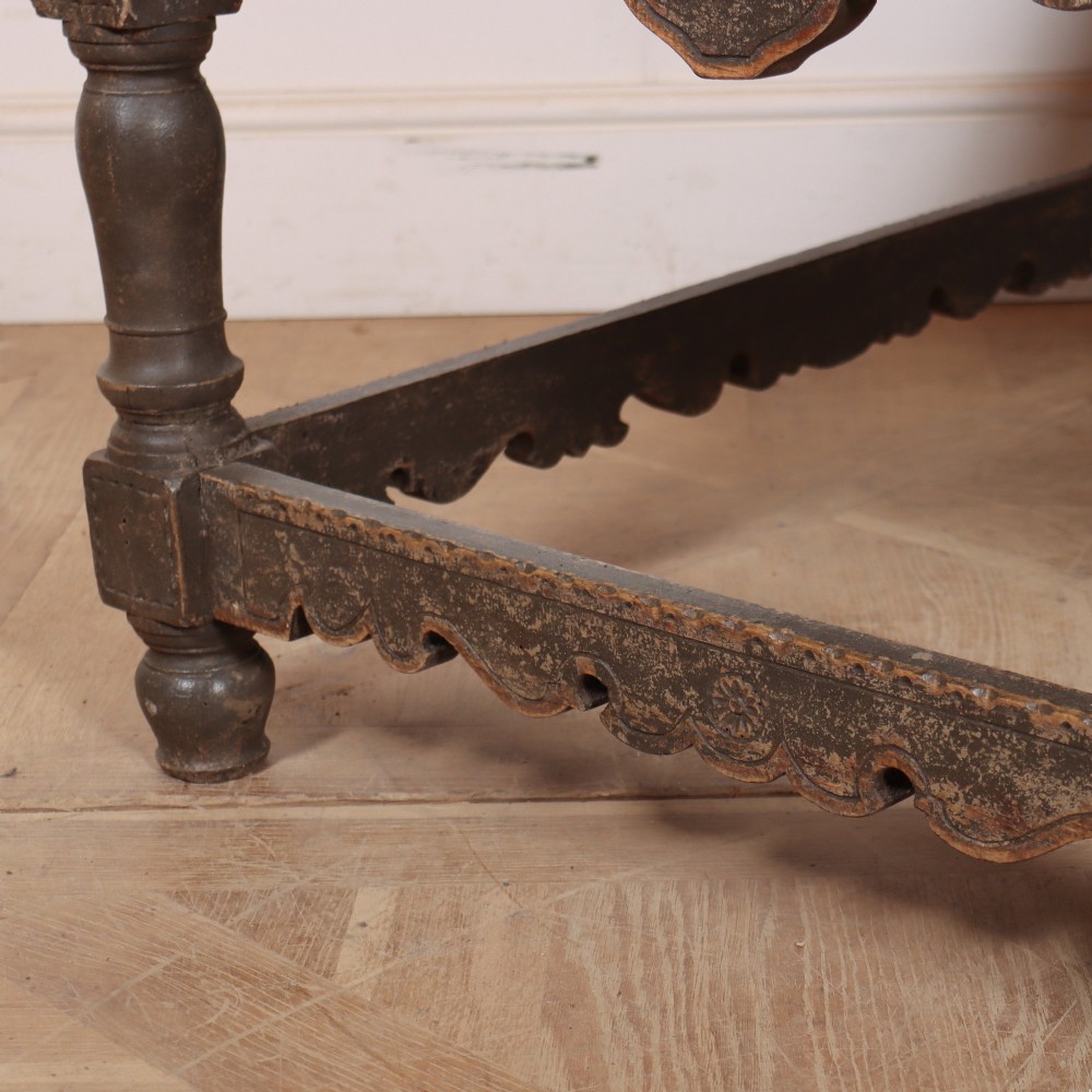 A low rectangular coffee table with a scrubbed pine top and dark painted frame featuring scalloped aprons, a carved shell motif, and turned legs. View VII