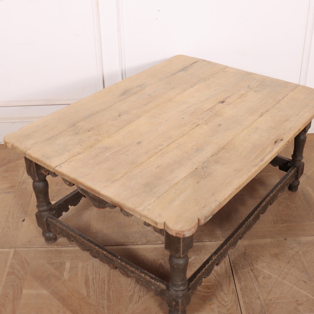 A low rectangular coffee table with a scrubbed pine top and dark painted frame featuring scalloped aprons, a carved shell motif, and turned legs. View VIII