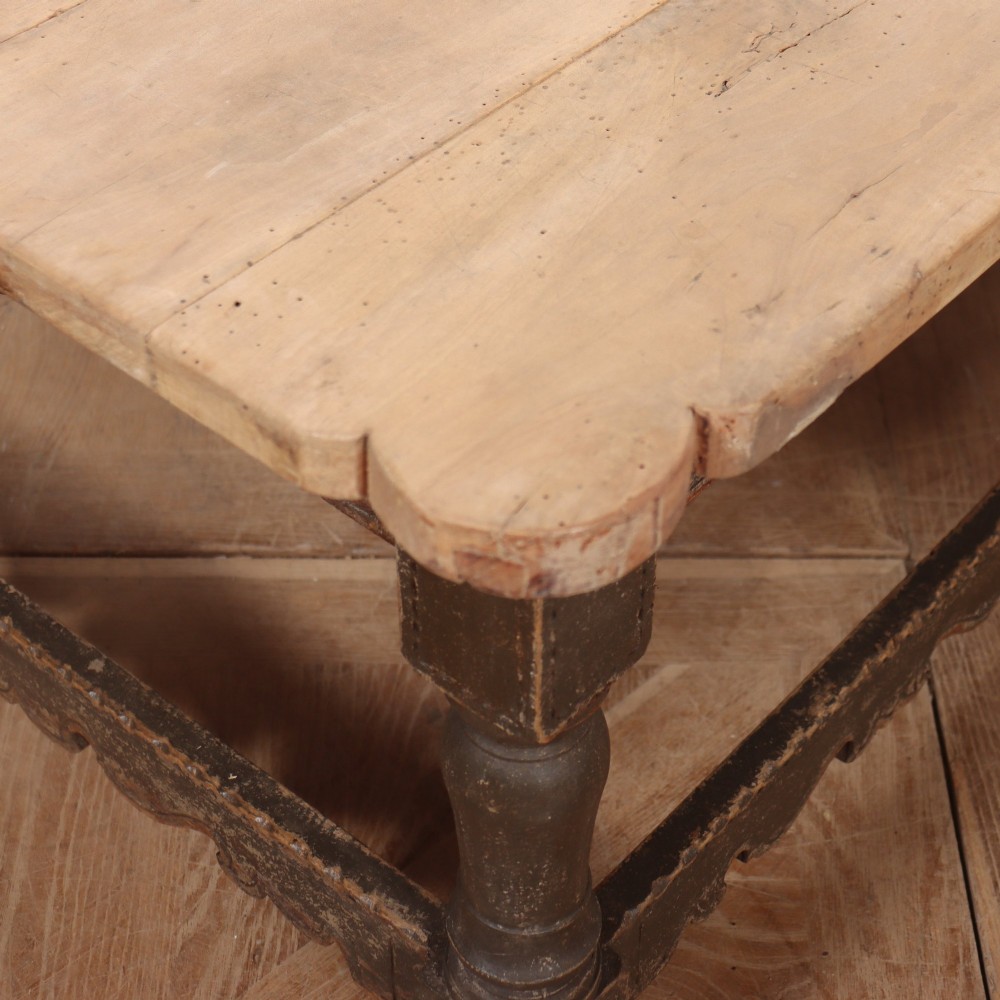 A low rectangular coffee table with a scrubbed pine top and dark painted frame featuring scalloped aprons, a carved shell motif, and turned legs. View IX