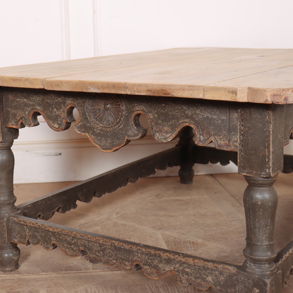 A low rectangular coffee table with a scrubbed pine top and dark painted frame featuring scalloped aprons, a carved shell motif, and turned legs. View XI