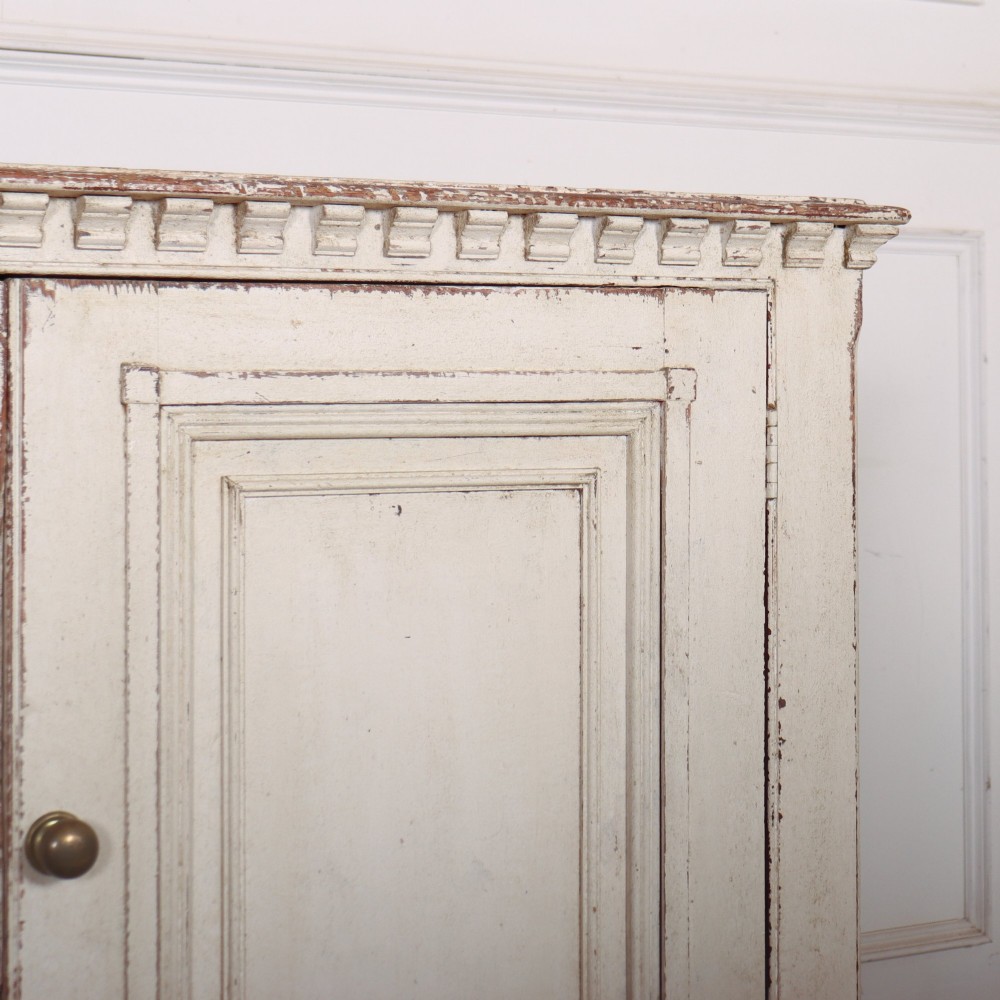 A long four-door Italian painted wooden enfilade with a distressed off-white finish, moulded cupboard panels, and bracket feet. View III