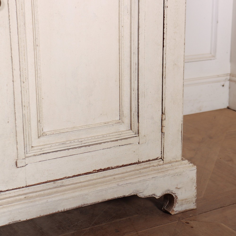 A long four-door Italian painted wooden enfilade with a distressed off-white finish, moulded cupboard panels, and bracket feet. View IV