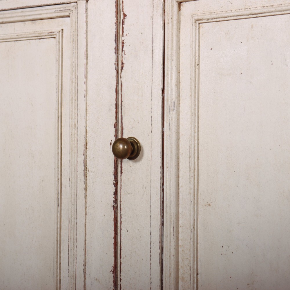 A long four-door Italian painted wooden enfilade with a distressed off-white finish, moulded cupboard panels, and bracket feet. View VI