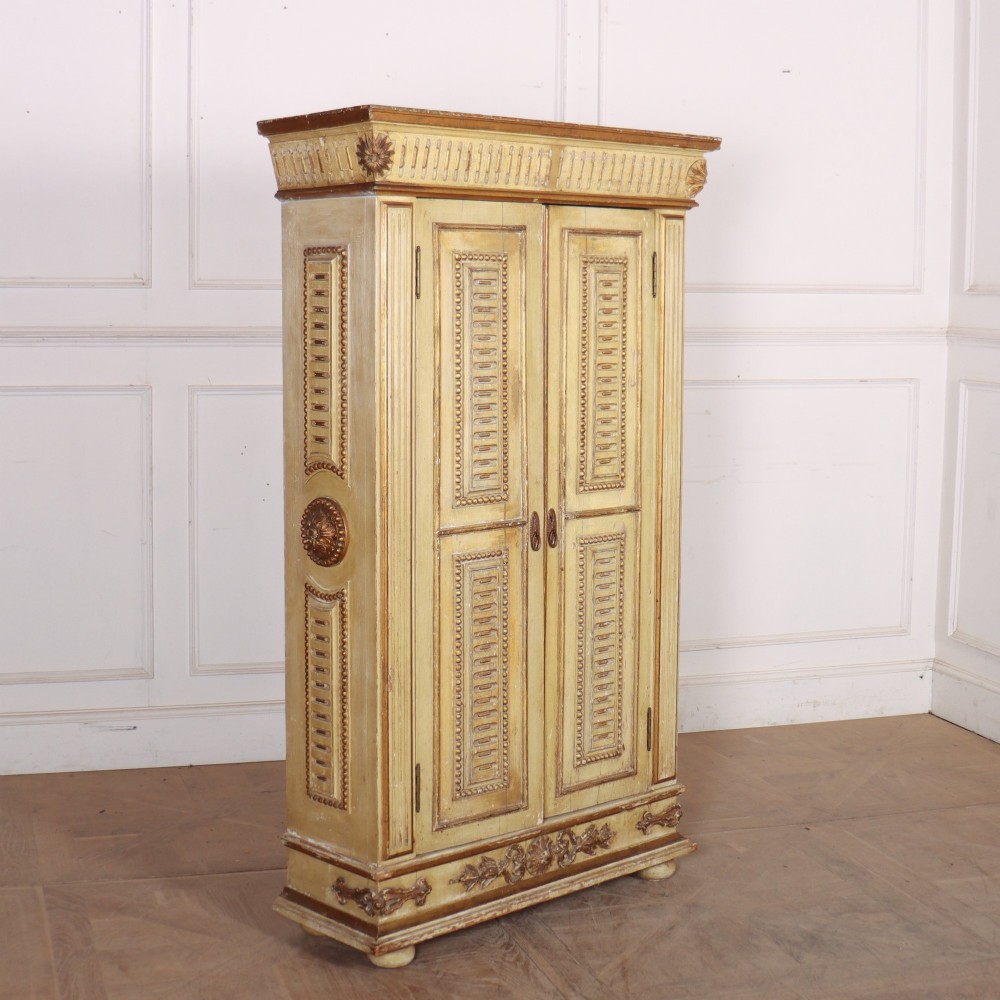 A late nineteenth-century Italian painted and gilded wooden cupboard featuring two tall doors with decorative carved panels, flanked by fluted pilasters on bun feet. View VIII