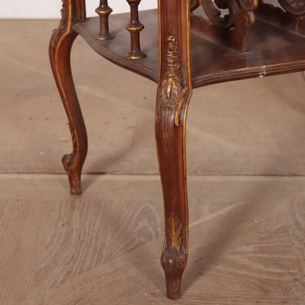 An antique French Rococo style wooden folio stand featuring carved openwork dividers, turned side spindles, cabriole legs, and parcel gilt detailing. View V