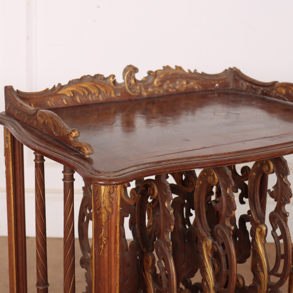 An antique French Rococo style wooden folio stand featuring carved openwork dividers, turned side spindles, cabriole legs, and parcel gilt detailing. View VI