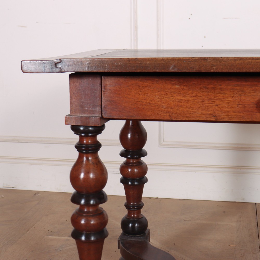 A warm brown wooden Italian side table desk featuring a single drawer with a round knob, heavy turned legs, and a shaped stretcher base. View II