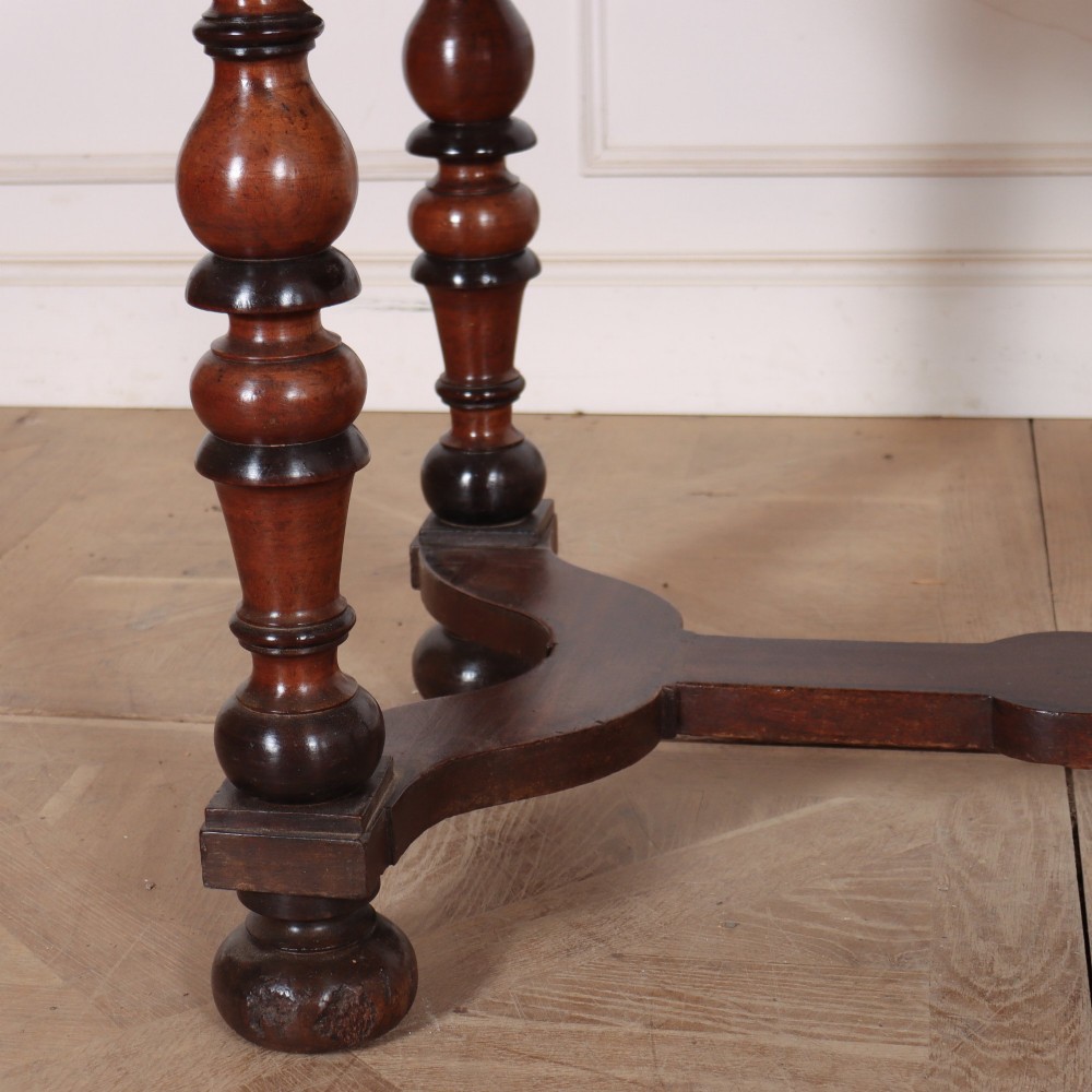 A warm brown wooden Italian side table desk featuring a single drawer with a round knob, heavy turned legs, and a shaped stretcher base. View III