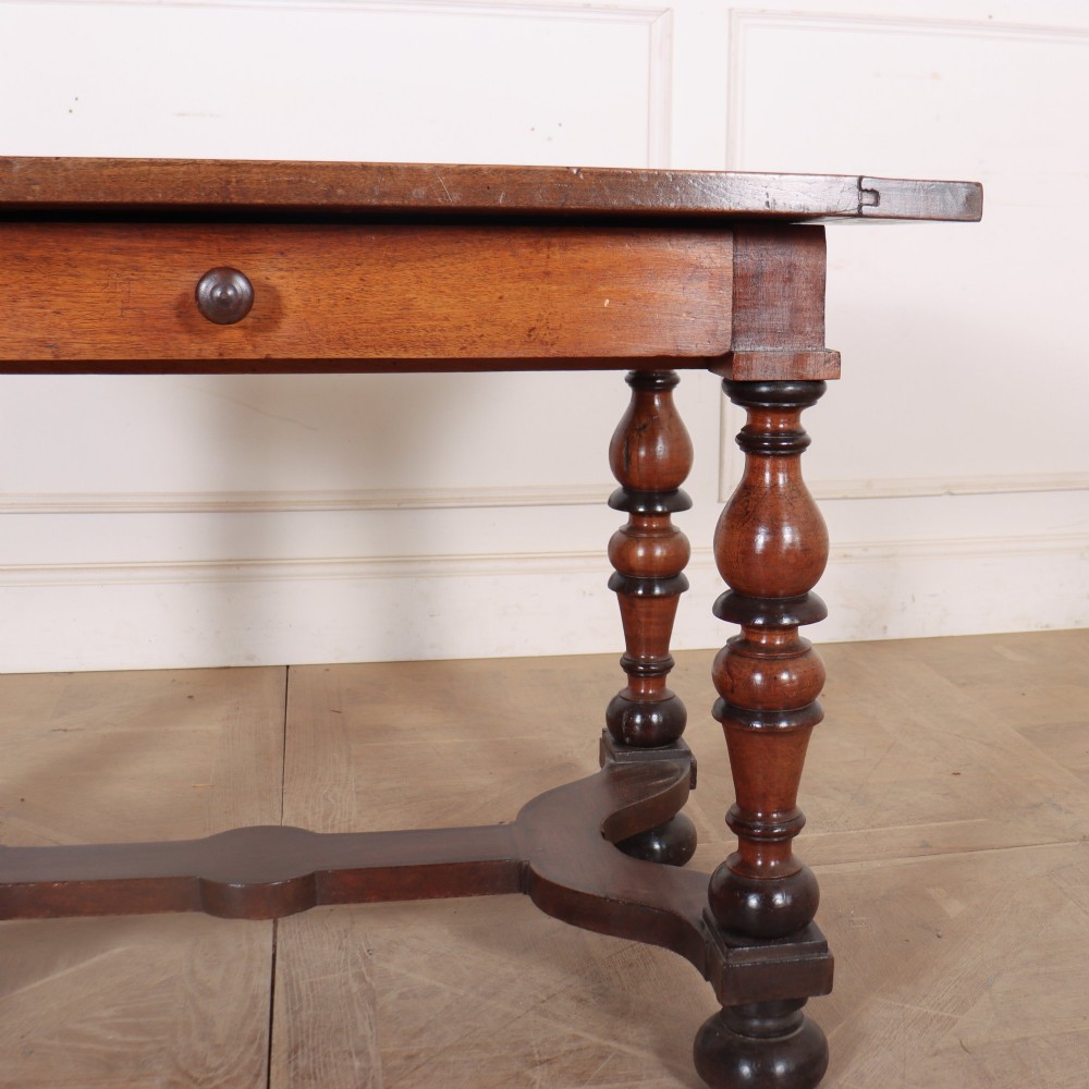 A warm brown wooden Italian side table desk featuring a single drawer with a round knob, heavy turned legs, and a shaped stretcher base. View V