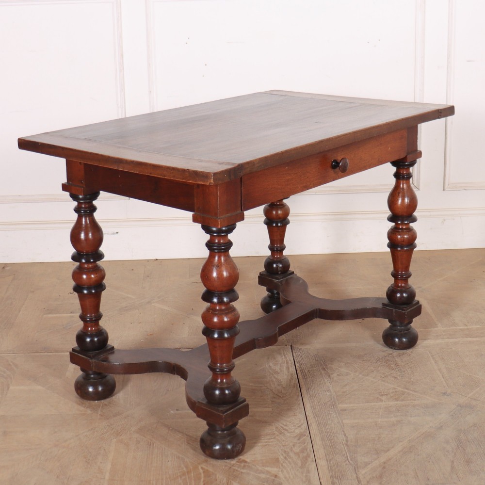 A warm brown wooden Italian side table desk featuring a single drawer with a round knob, heavy turned legs, and a shaped stretcher base. View VI