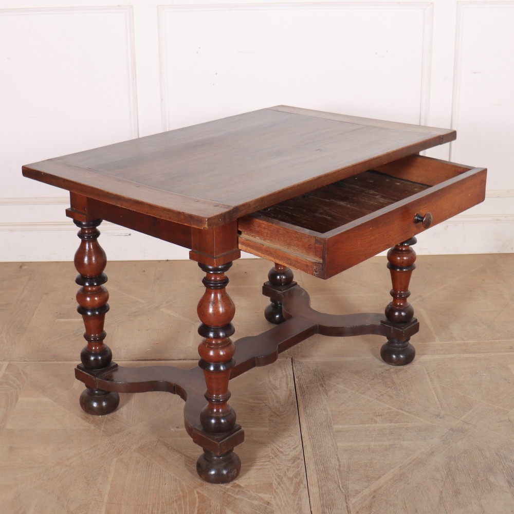 A warm brown wooden Italian side table desk featuring a single drawer with a round knob, heavy turned legs, and a shaped stretcher base. View VII