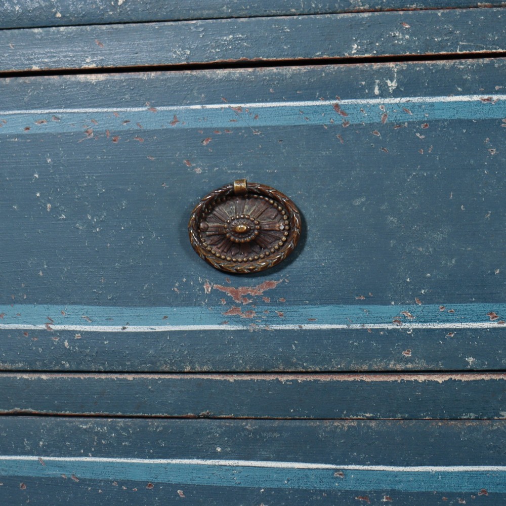 An antique English bowfront chest of drawers with a distressed blue painted finish, painted line borders, and bobbin-turned columns. View VI