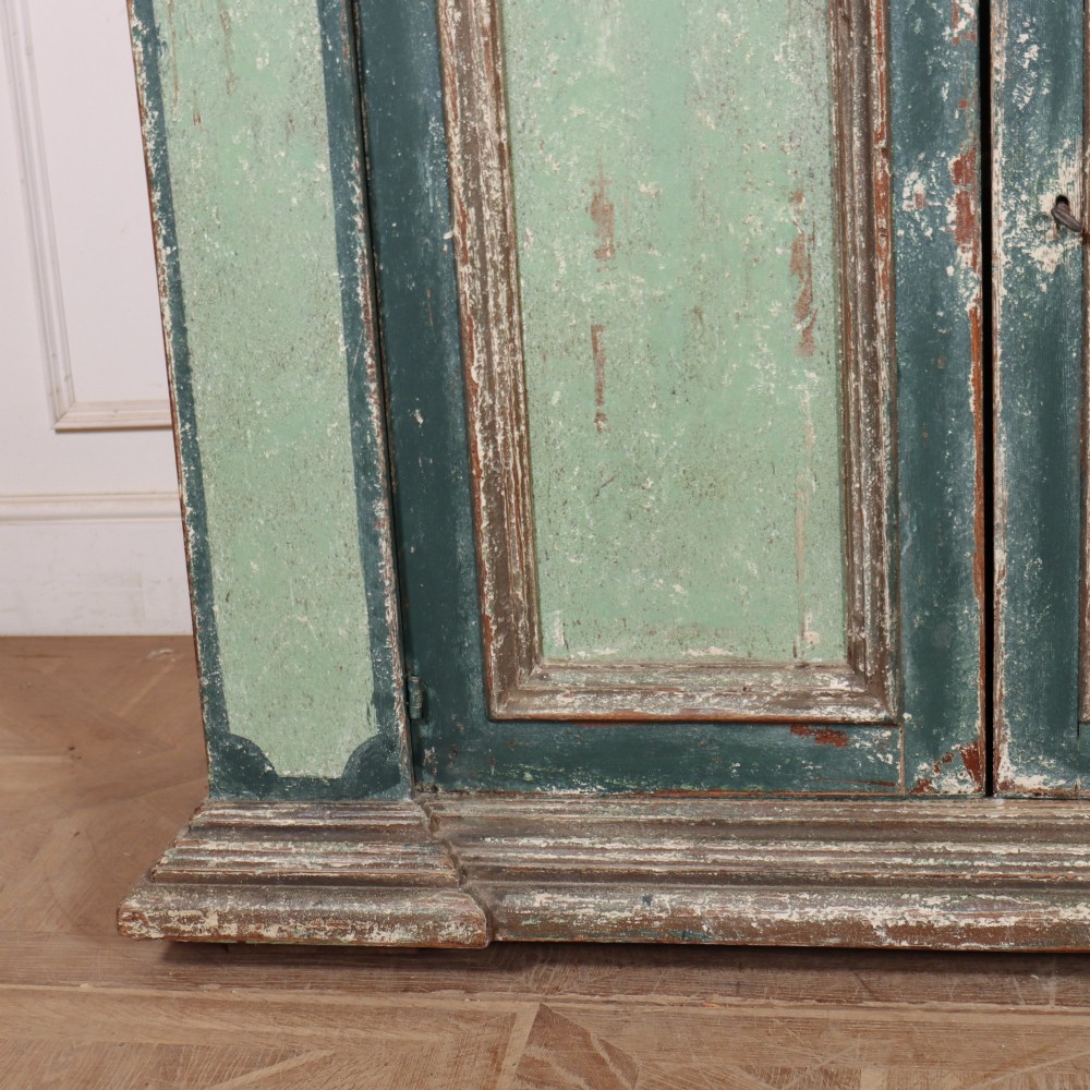 A long rectangular antique Italian side cabinet featuring four panelled doors in a distressed sage and teal painted finish with a plinth base. View III