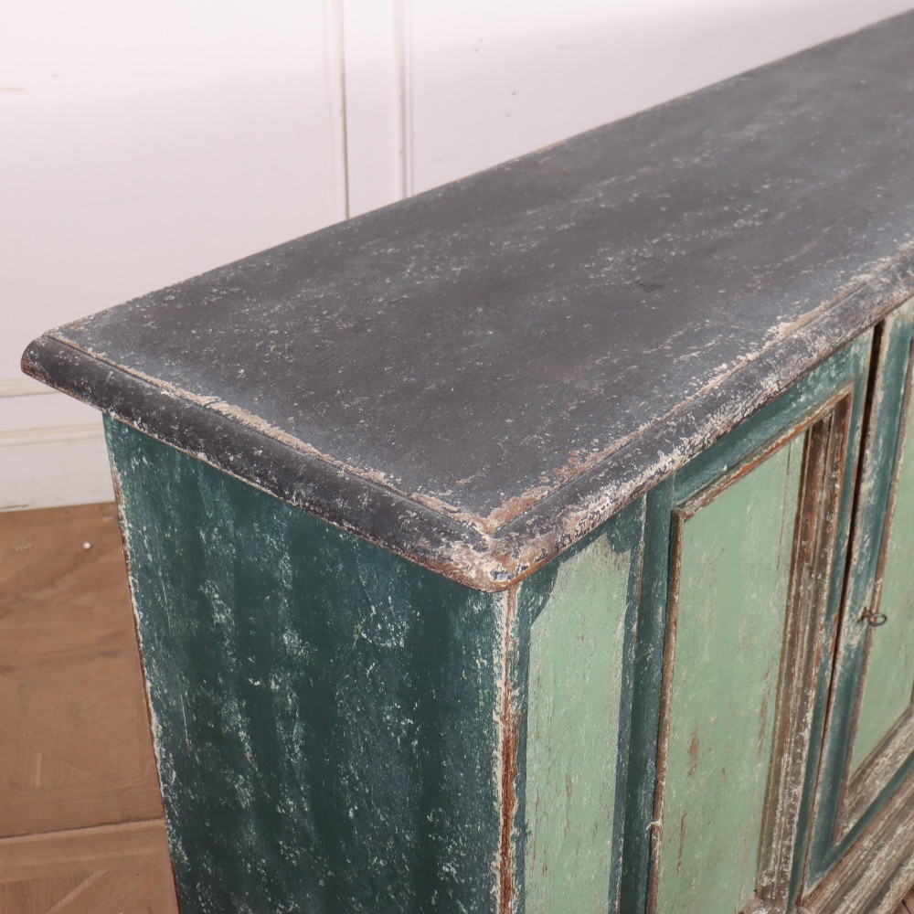 A long rectangular antique Italian side cabinet featuring four panelled doors in a distressed sage and teal painted finish with a plinth base. View XIII