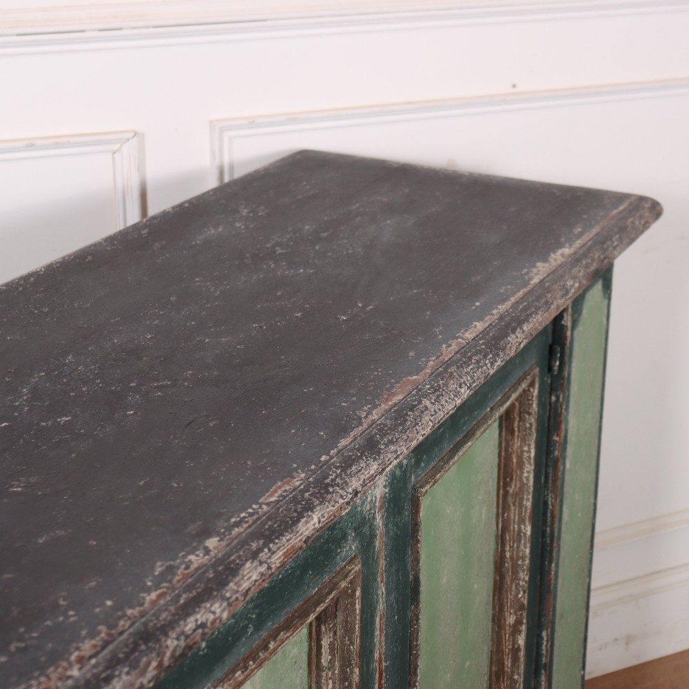 A long rectangular antique Italian side cabinet featuring four panelled doors in a distressed sage and teal painted finish with a plinth base. View XIV