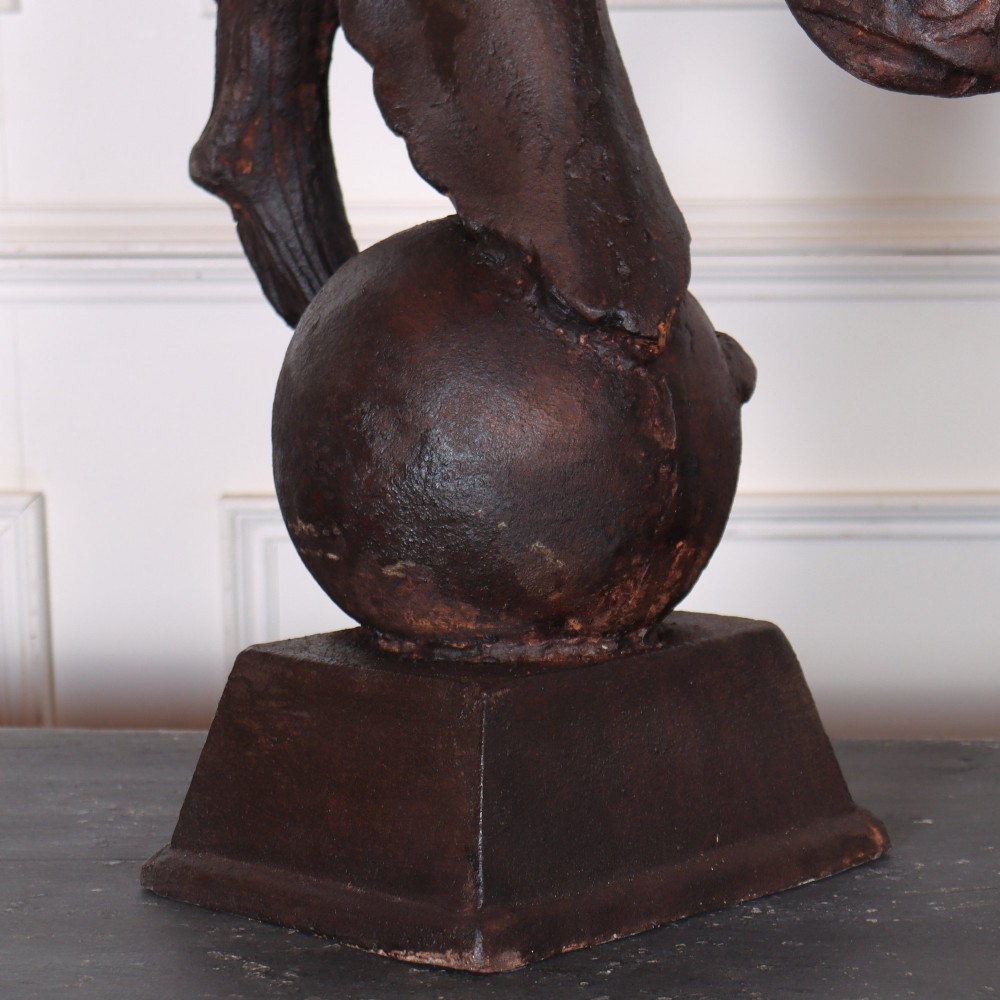 A pair of dark brown cast iron horse head sculptures mounted on spherical supports with square plinth bases. View VII