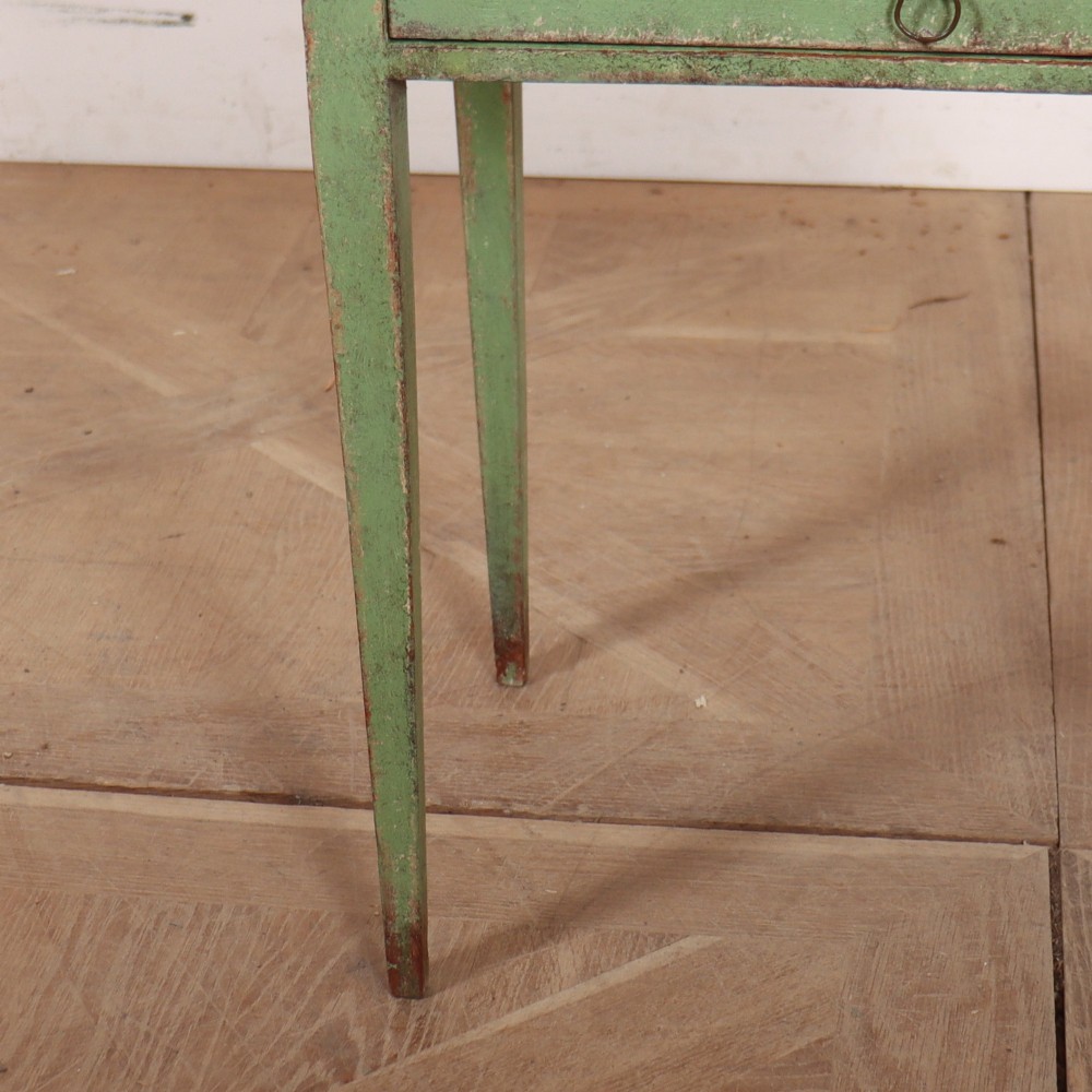 A Dutch provincial green painted bedside table with a slatted tambour door, lower drawer, and tapered square legs. View V