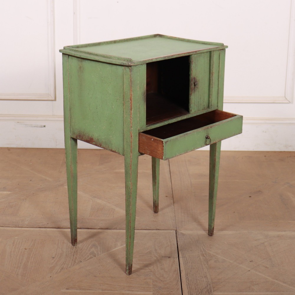 A Dutch provincial green painted bedside table with a slatted tambour door, lower drawer, and tapered square legs. View VIII