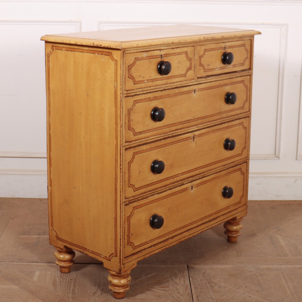 An antique yellow painted pine chest of drawers with two small drawers over three full-width drawers, featuring dark line border detailing, timber knobs, and turned feet. View VII