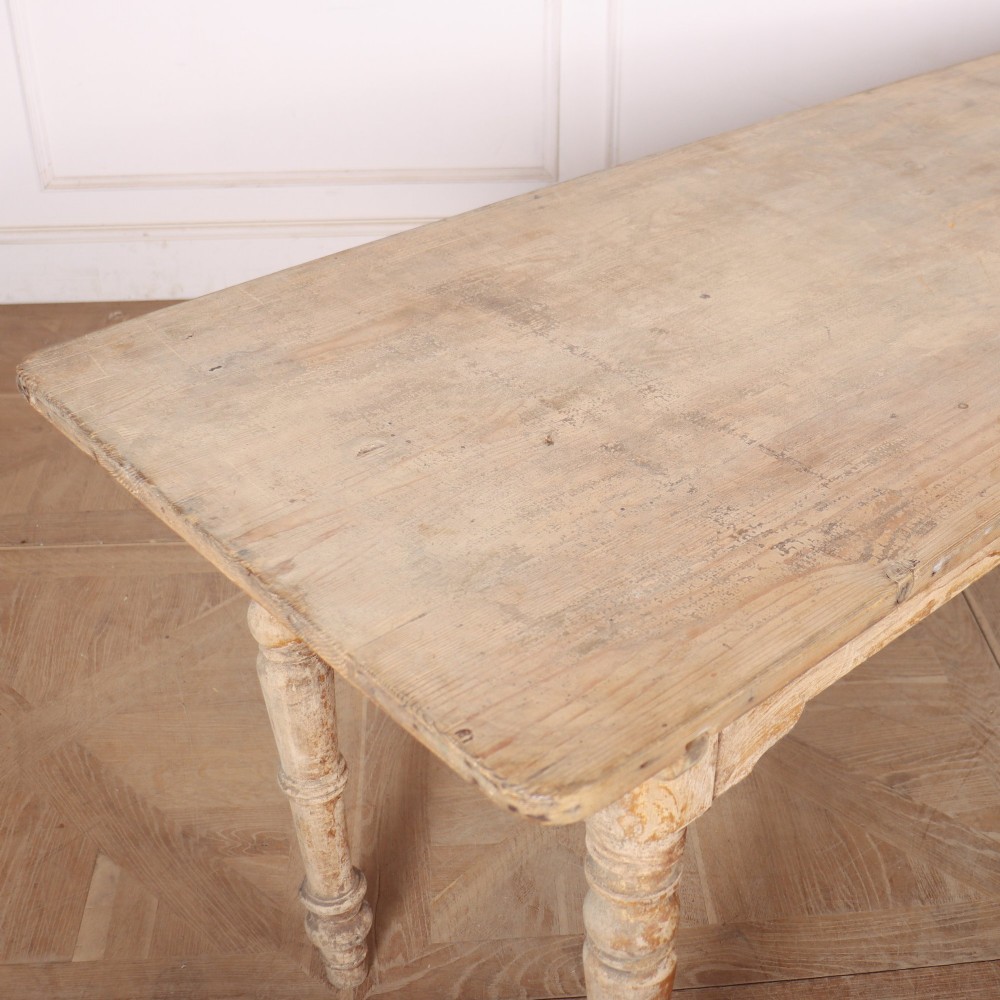 A long antique Italian painted wood farm table with turned legs and a distressed cream finish. View V