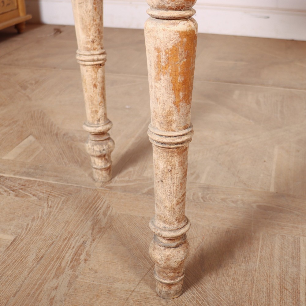 A long antique Italian painted wood farm table with turned legs and a distressed cream finish. View VI