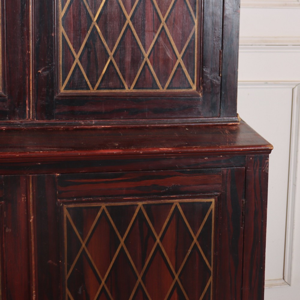A tall 19th-century dark painted wooden cupboard with two tiers of double doors decorated with gold painted diamond lattice panels. View IV