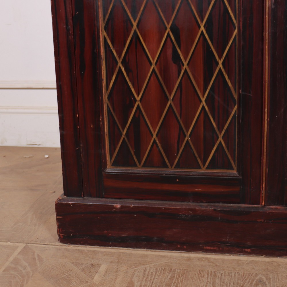 A tall 19th-century dark painted wooden cupboard with two tiers of double doors decorated with gold painted diamond lattice panels. View VI