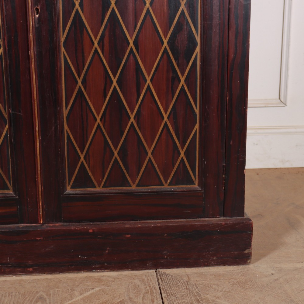 A tall 19th-century dark painted wooden cupboard with two tiers of double doors decorated with gold painted diamond lattice panels. View VII