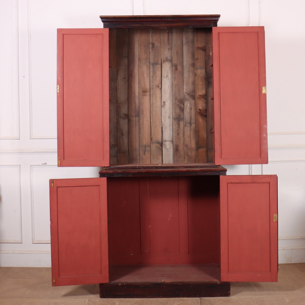 A tall 19th-century dark painted wooden cupboard with two tiers of double doors decorated with gold painted diamond lattice panels. View VIII
