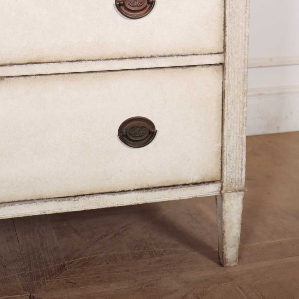 A tall off-white painted Scandinavian style linen cupboard featuring a two-door upper section above three drawers with circular brass handles. View VIII