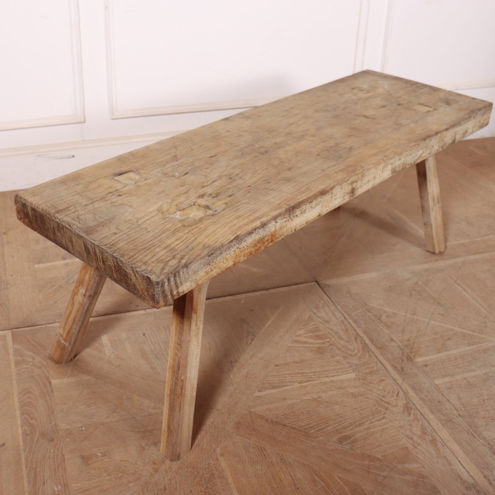 A low rectangular wooden coffee table crafted from thick timber with four splayed legs. View II
