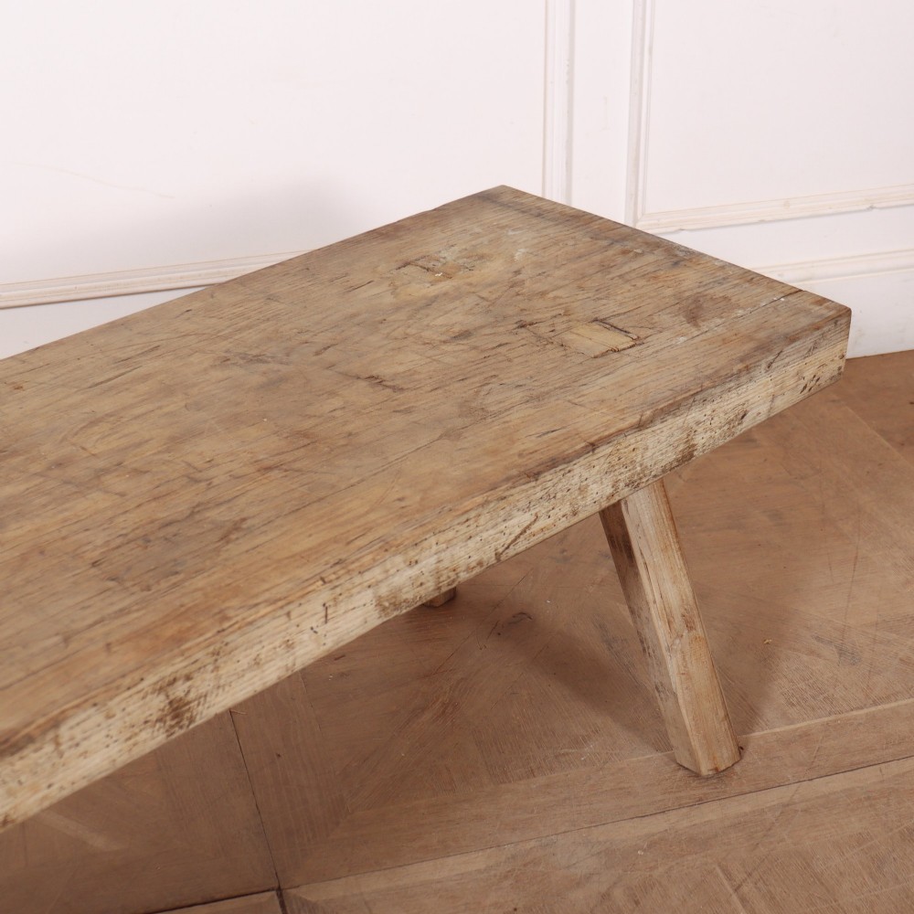 A low rectangular wooden coffee table crafted from thick timber with four splayed legs. View III
