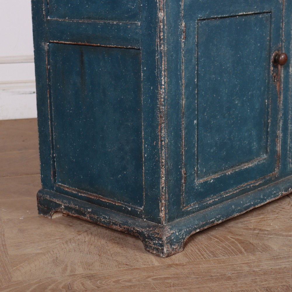 A blue-painted two-part timber dresser featuring an upper section with two glazed six-pane doors and a lower base with three drawers above three panelled cupboard doors. View XI