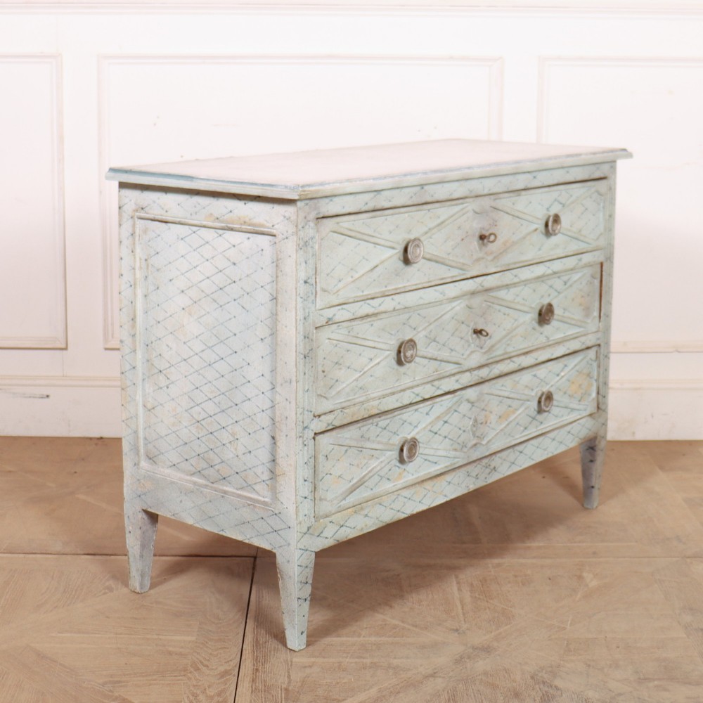 A pale blue painted Spanish commode with three drawers decorated with a distressed diamond lattice pattern and metallic ring pulls. View VI