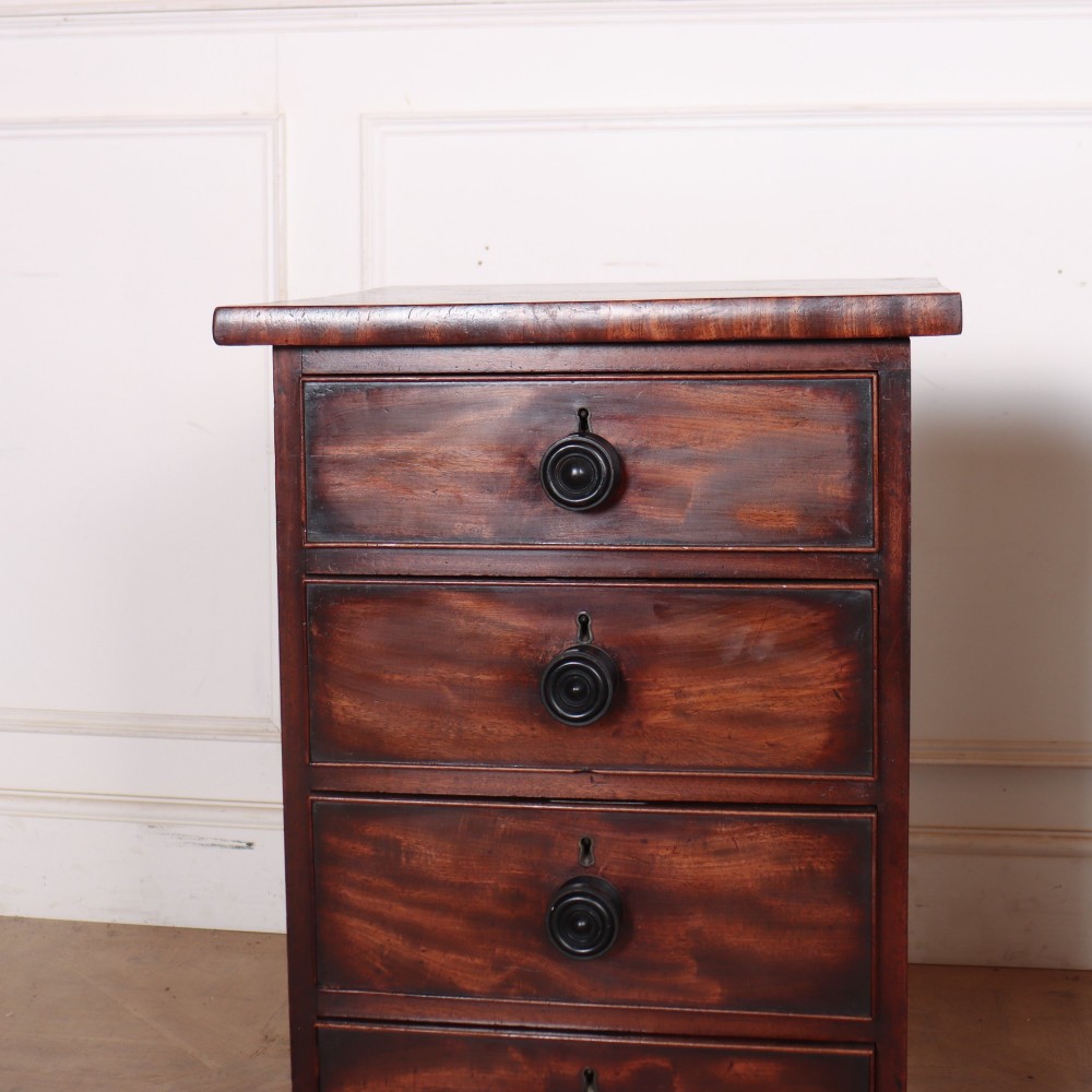 A matching pair of dark mahogany bedside chests, each featuring four drawers with turned wooden knobs and bracket feet. View II