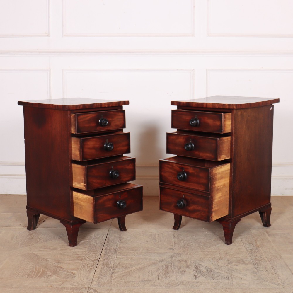 A matching pair of dark mahogany bedside chests, each featuring four drawers with turned wooden knobs and bracket feet. View VI